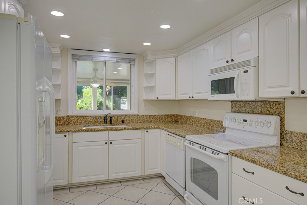 Kitchen has ample cabinet storage and countertop space. Window looks onto the converted patio. - 2 Via Castilla E, Laguna Woods CA 92637 - photo 8