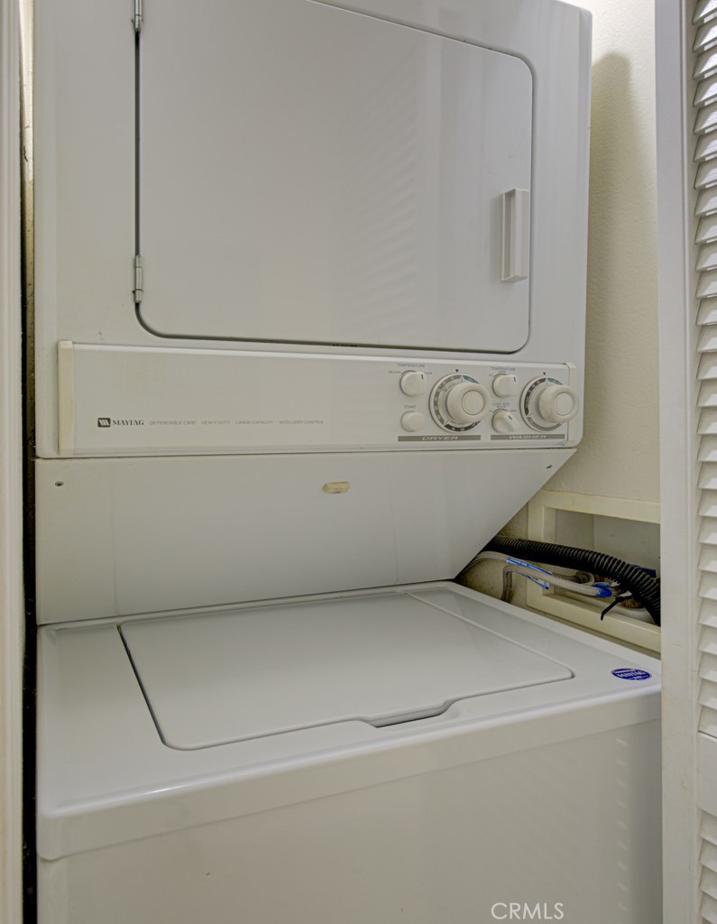 Stackable washer-dryer is conveniently located in the hallway. - 2 Via Castilla E, Laguna Woods CA 92637 - photo 20