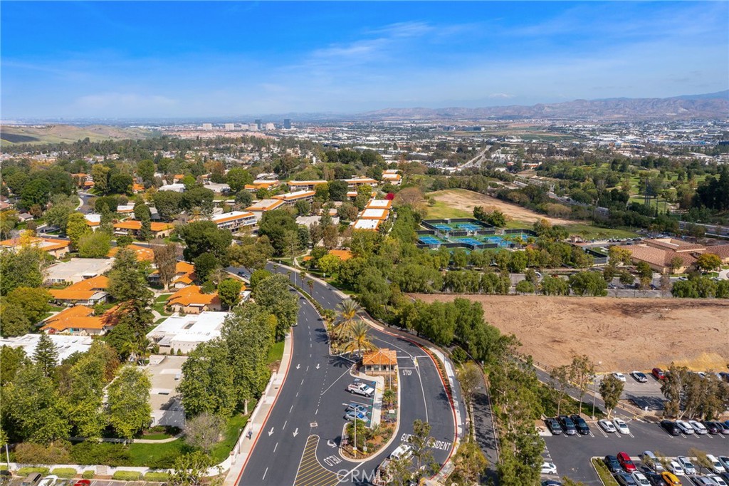 Aerial view of a gated community entrance with recreation courts beyond. Residents enjoy a 10-court tennis complex and s - 225 Avenida Majorca N, Laguna Woods CA 92637 - photo 21