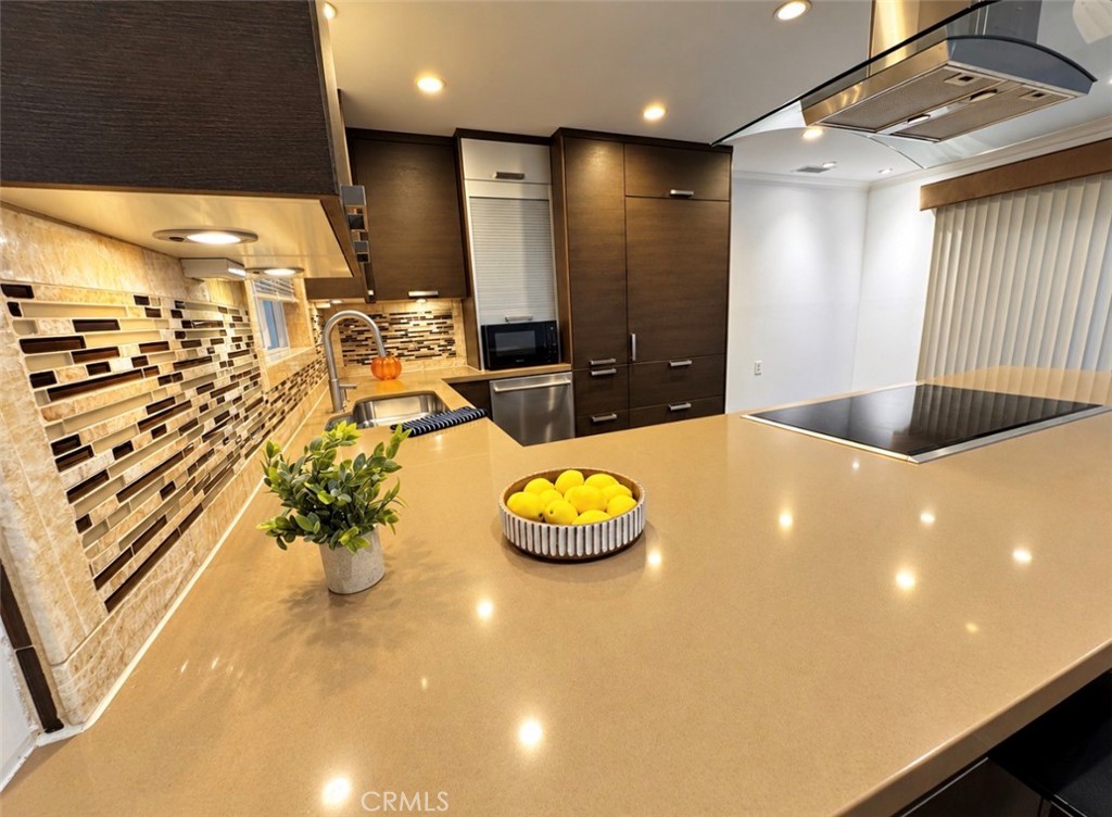 Beautiful quartz countertops and Gleaming quartz countertops with warm under-cabinet lighting, ideal for cooking and ent - 2346 Via Mariposa W A, Laguna Woods CA 92637 - photo 9