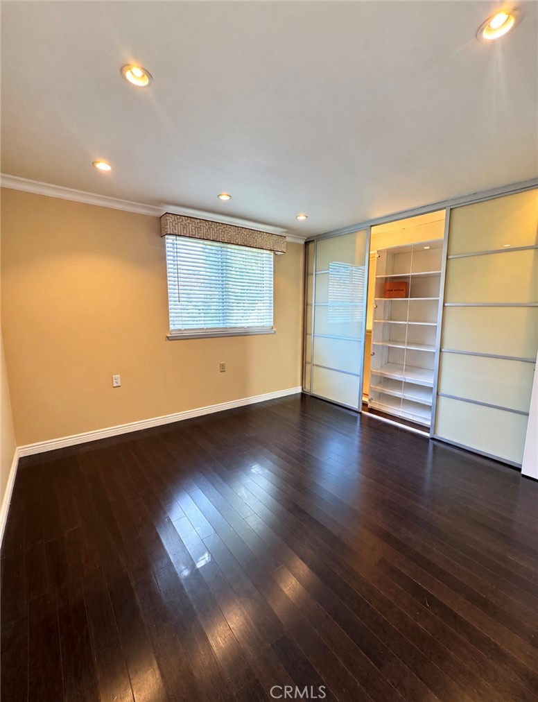 Secondary bedroom also has the built-in glass-enclosed shelving to showcase your collectibles and keepsakes. - 2346 Via Mariposa W A, Laguna Woods CA 92637 - photo 18