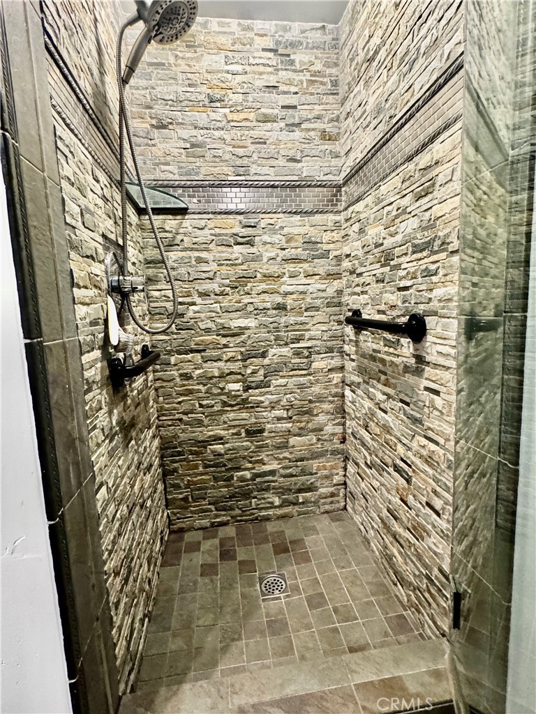 Slip into the spa-inspired walk-in shower in the primary bath, where custom tile work adds a touch of luxury to your dai - 2346 Via Mariposa W A, Laguna Woods CA 92637 - photo 21