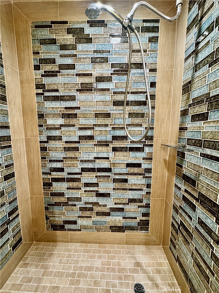 Indulge in the secondary bath’s oversized walk-in shower, finished in custom tile for a truly luxe, resort-style experie - 2346 Via Mariposa W A, Laguna Woods CA 92637 - photo 24