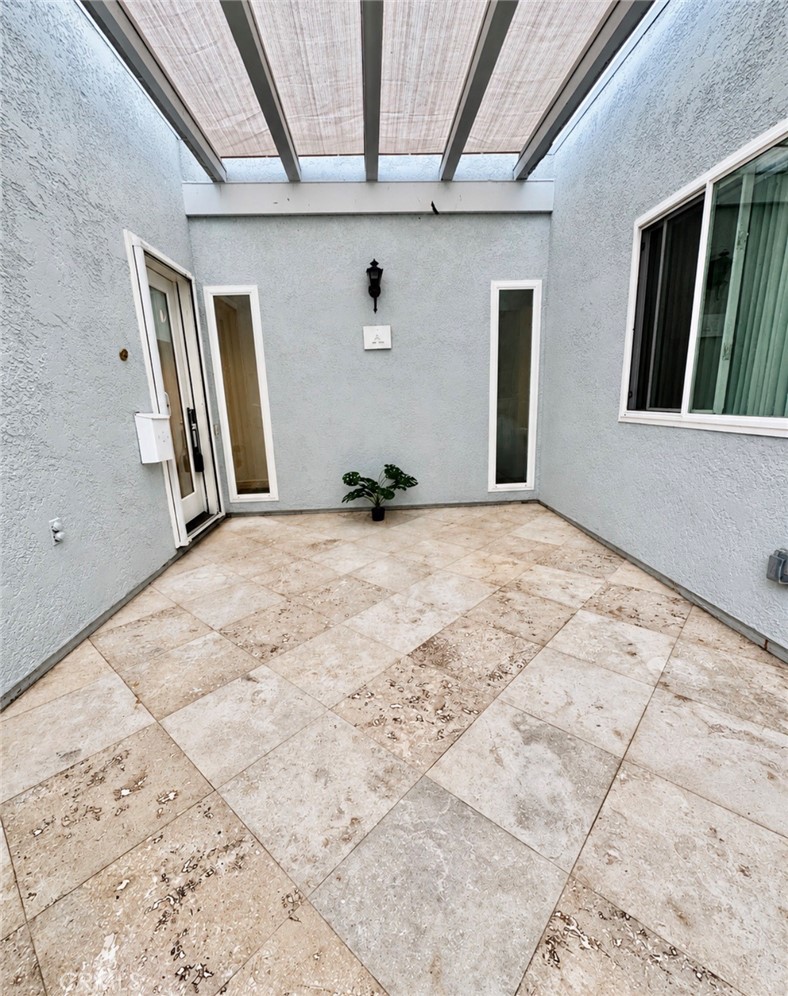 Step through the private gated entry, where travertine tile flooring sets an elegant tone from the moment you arrive. - 2346 Via Mariposa W A, Laguna Woods CA 92637 - photo 29