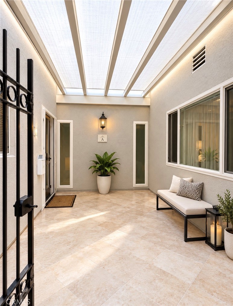 Step through the private gated entry, where travertine tile flooring sets an elegant tone from the moment you arrive (Vi - 2346 Via Mariposa W A, Laguna Woods CA 92637 - photo 28