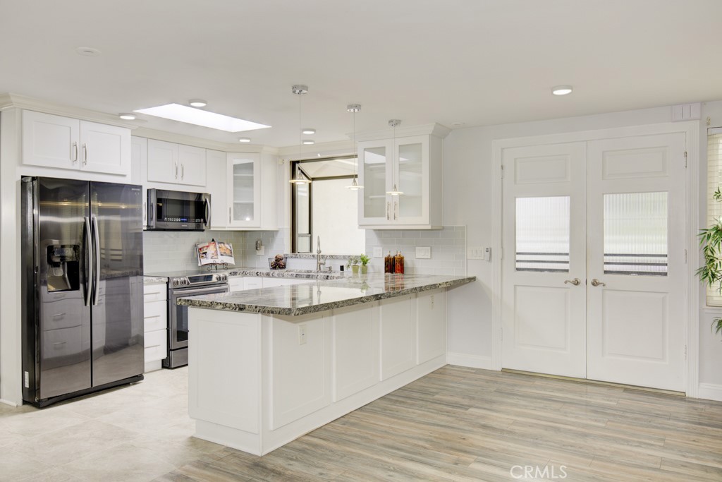 Exquisitely upgraded kitchen opens to the living room. - 245 Calle Aragon C, Laguna Woods CA 92637 - photo 1