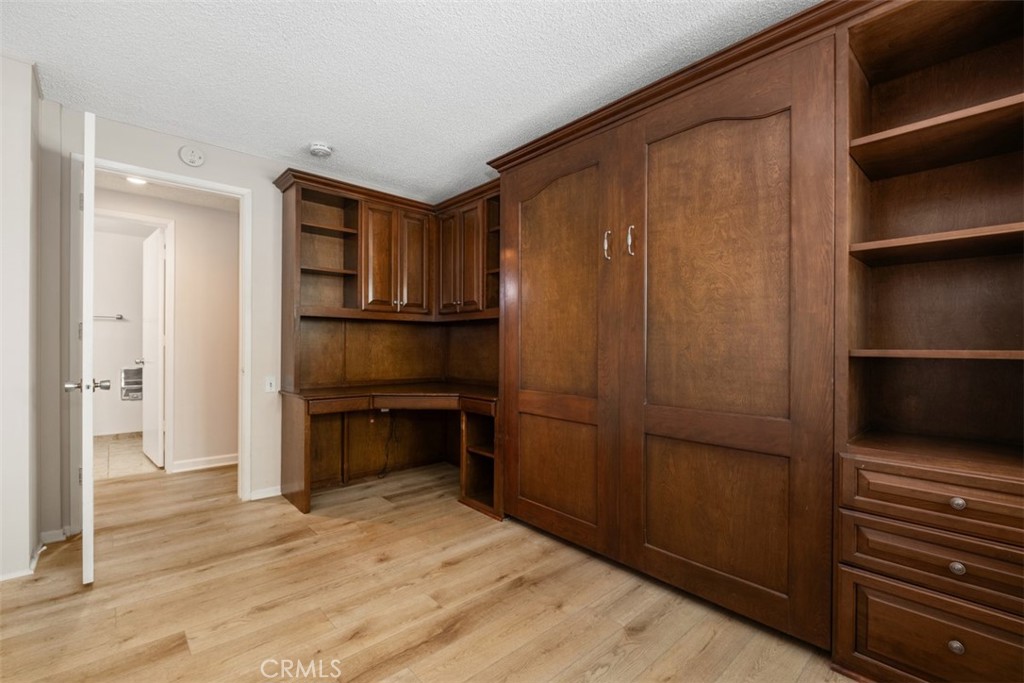 Murphy bed featuring an integrated desk, drawers, and built-in shelving unit. - 270 Avenida Sevilla D, Laguna Woods CA 92637 - photo 29