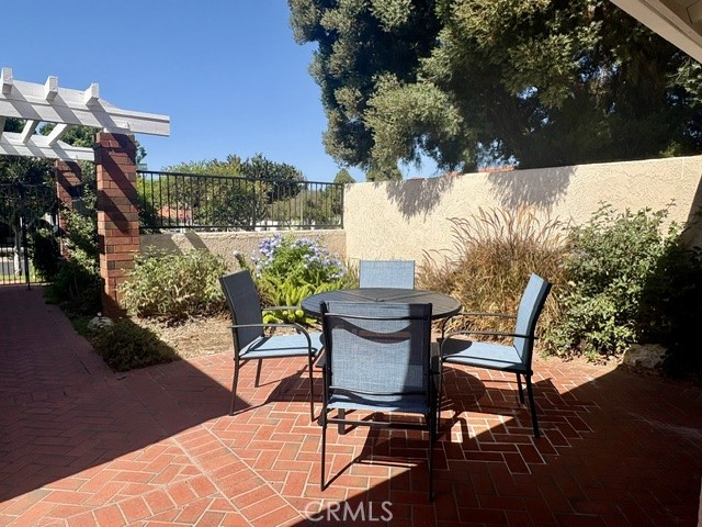The large front courtyard is beautifully landscaped and is the ideal setting for outdoor entertaining, dining and relaxi - 3386 Punta Alta A, Laguna Woods CA 92637 - photo 2