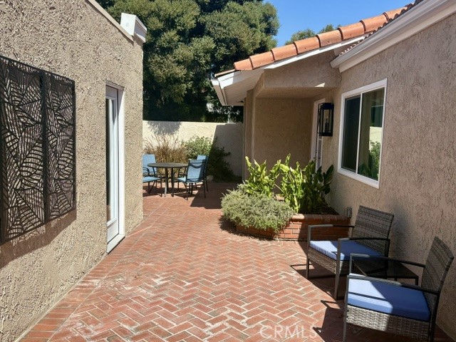 Another view of the side patio looking back towards the front courtyard. - 3386 Punta Alta A, Laguna Woods CA 92637 - photo 5
