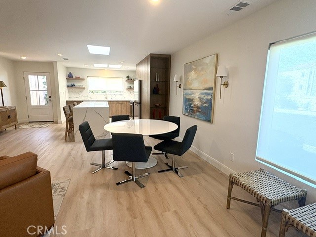 Another view of the dining area looking back towards the front door at left and the kitchen. - 3386 Punta Alta A, Laguna Woods CA 92637 - photo 11