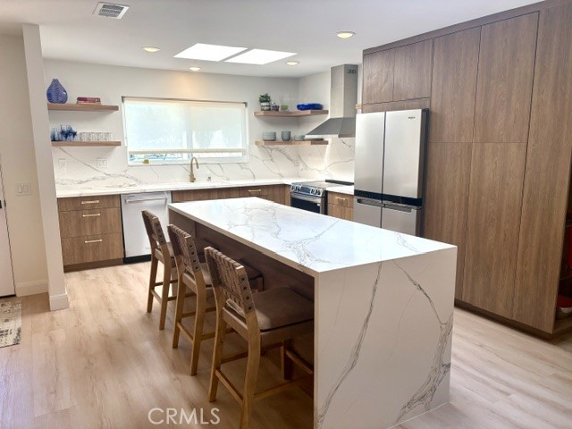 Remodeled kitchen features a large island with added storage and seating for up to four. - 3386 Punta Alta A, Laguna Woods CA 92637 - photo 12