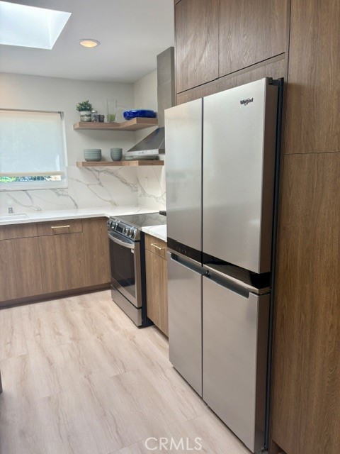 Kitchen features include stainless steel appliances. - 3386 Punta Alta A, Laguna Woods CA 92637 - photo 13