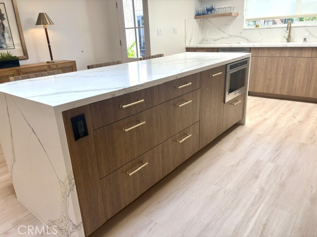 Cabinet storage in the kitchen island. - 3386 Punta Alta A, Laguna Woods CA 92637 - photo 16