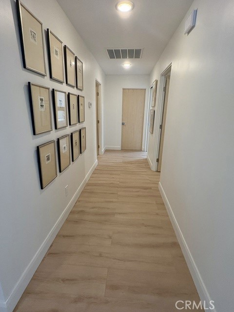 Hallway leading to bedrooms and bathrooms. - 3386 Punta Alta A, Laguna Woods CA 92637 - photo 17