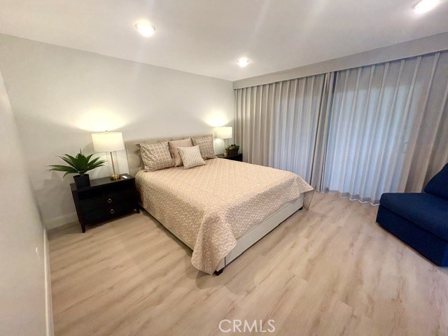 Spacious primary bedroom suite has direct access to the rear patio. - 3386 Punta Alta A, Laguna Woods CA 92637 - photo 18