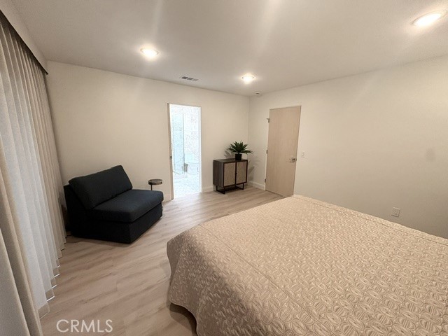 Another view of the primary bedroom suite. Open doorway leads to the primary bathroom. - 3386 Punta Alta A, Laguna Woods CA 92637 - photo 19