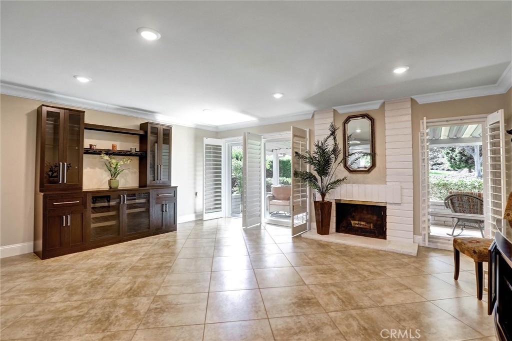 Wood-burning fireplace serves as a cozy focal point - 3400 Punta Alta A, Laguna Woods CA 92637 - photo 18