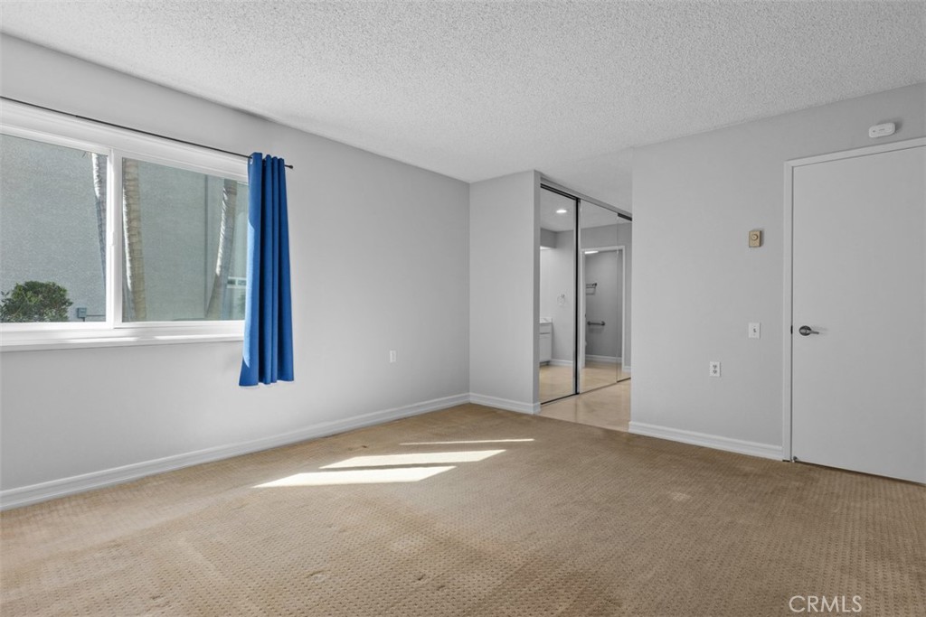 Primary bedroom to bath and closet - 3438 Bahia Blanca W, Laguna Woods CA 92637 - photo 28
