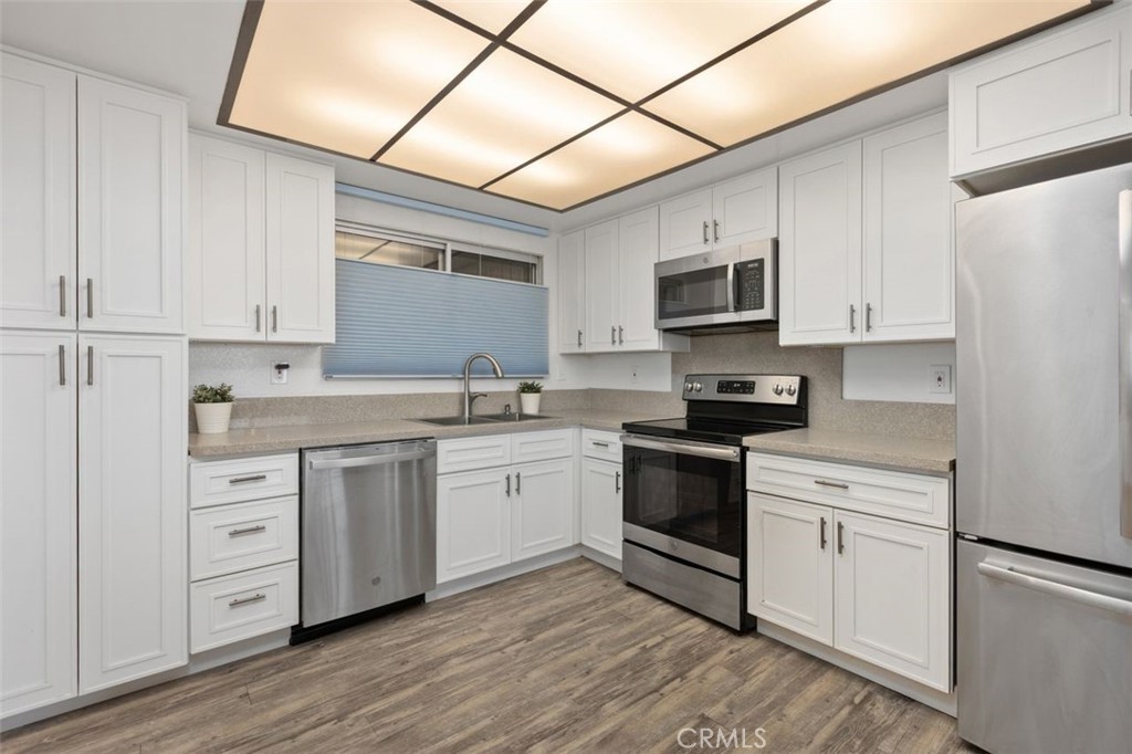 Roomy Kitchen with Stainless Steel refridgerator, dishwasher, microwave, and oven. - 4013 Calle Sonora Oeste Unit 2E, Laguna Woods CA 92637 - photo 13