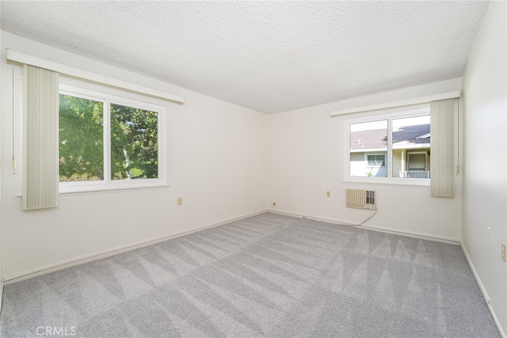Primary bedroom with AC, new carpet and extra windows! - 476 Calle Cadiz O, Laguna Woods CA 92637 - photo 17