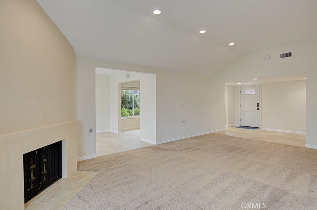 Another view of the living room looking back towards the dining area and the front door. - 5016 Jardin, Laguna Woods CA 92637 - photo 8
