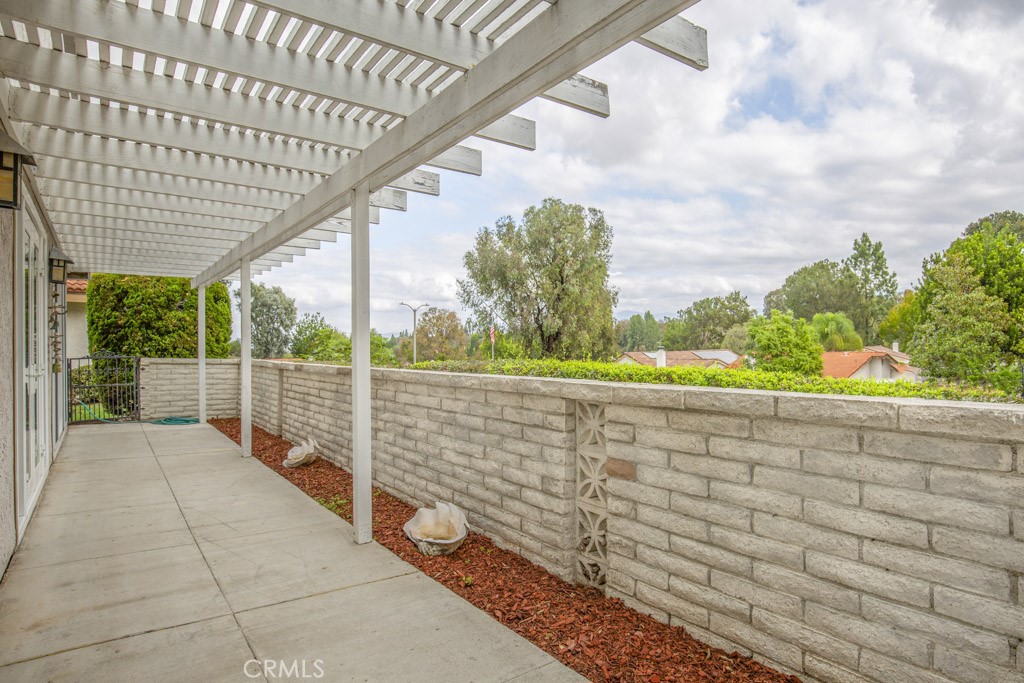 Rear patio extends the entire length of the residence and is accessible from the living room, dining area and primary be - 5016 Jardin, Laguna Woods CA 92637 - photo 10