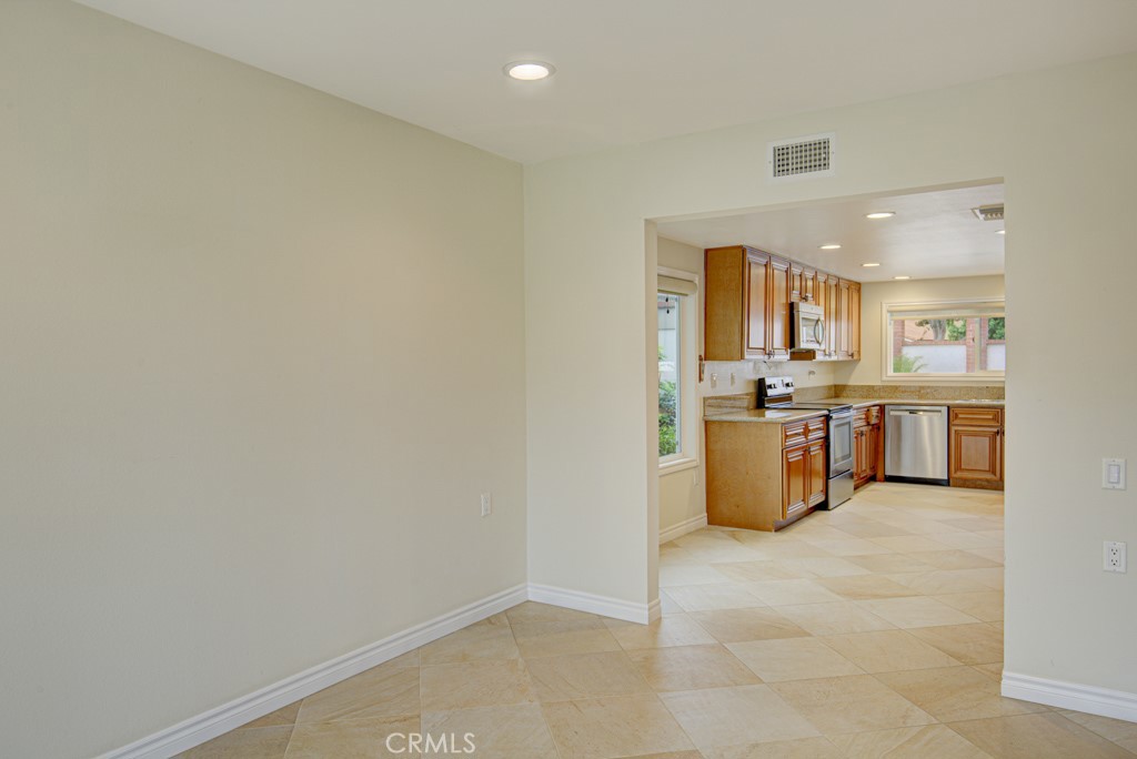 Looking into the kitchen from the dining area. - 5016 Jardin, Laguna Woods CA 92637 - photo 12