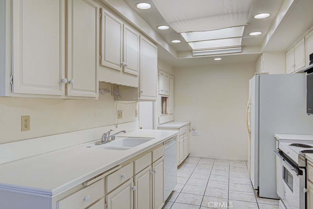 Kitchen is light and bright with large skylights. - 5380 Avenida Sosiega B, Laguna Woods CA 92637 - photo 9