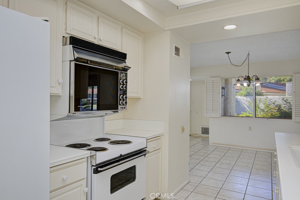 Another view of the kitchen looking back towards the dining area. - 5380 Avenida Sosiega B, Laguna Woods CA 92637 - photo 11