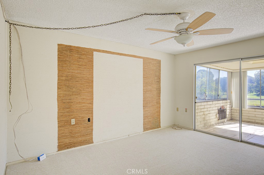 Left side bedroom has direct access to the enclosed rear patio via a glass slider. - 5380 Avenida Sosiega B, Laguna Woods CA 92637 - photo 16