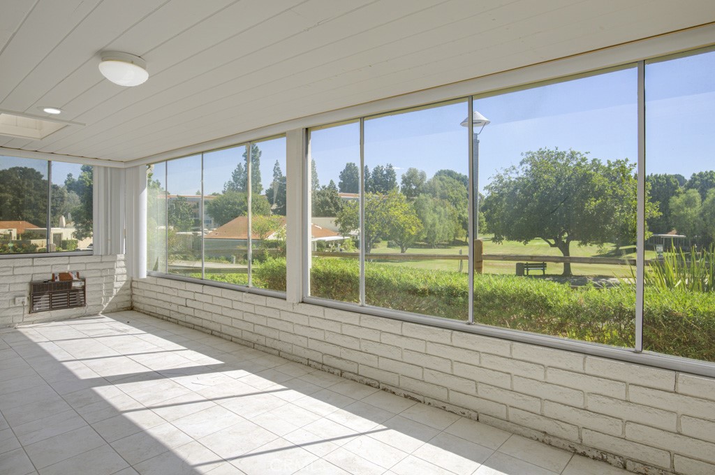 Enclosed rear patio has a lovely panoramic view of the neighborhood, trees and golf course. - 5380 Avenida Sosiega B, Laguna Woods CA 92637 - photo 27
