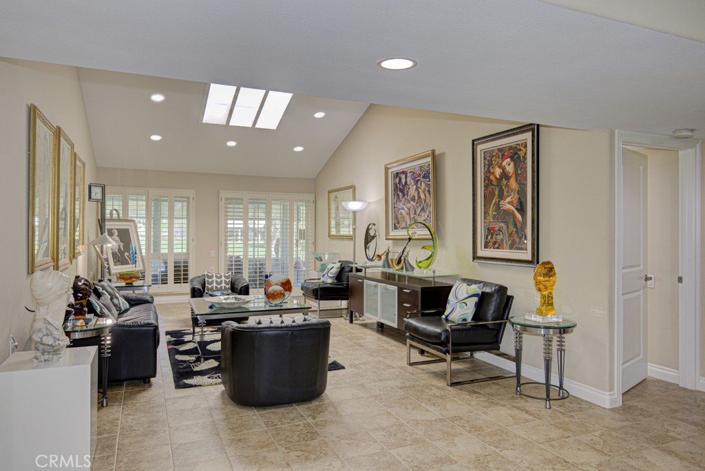 Another view of the living room. Note the beautiful tile flooring. Entry to one of the bedrooms can be seen at far right - 5516 Paseo Del Lago W A, Laguna Woods CA 92637 - photo 4