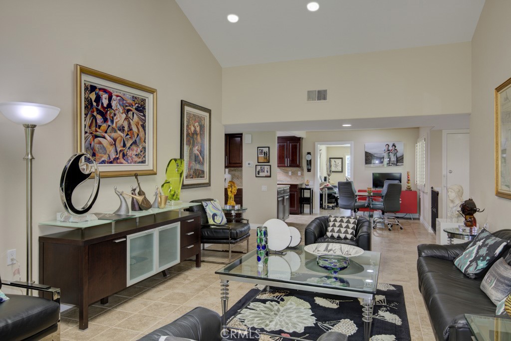 Another view of the living room looking back towards the dining room and bonus room in the distance. - 5516 Paseo Del Lago W A, Laguna Woods CA 92637 - photo 5