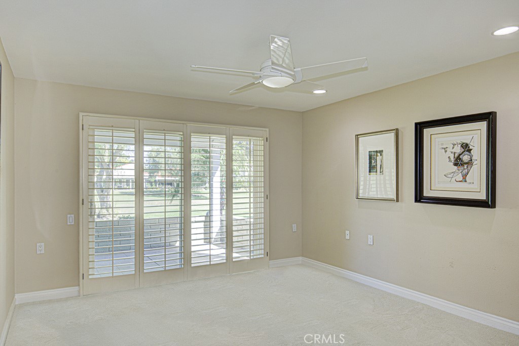 Right-side bedroom suite has access to a small open patio with a lovely golf course view. - 5516 Paseo Del Lago W A, Laguna Woods CA 92637 - photo 15