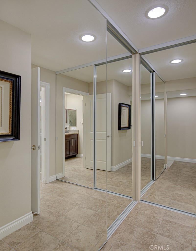 Mirrored closet doors in the right-side bedroom suite. - 5516 Paseo Del Lago W A, Laguna Woods CA 92637 - photo 17