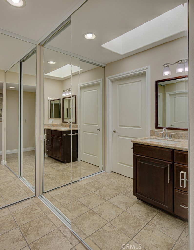 Mirrored closet doors in the left-side bedroom suite. - 5516 Paseo Del Lago W A, Laguna Woods CA 92637 - photo 24