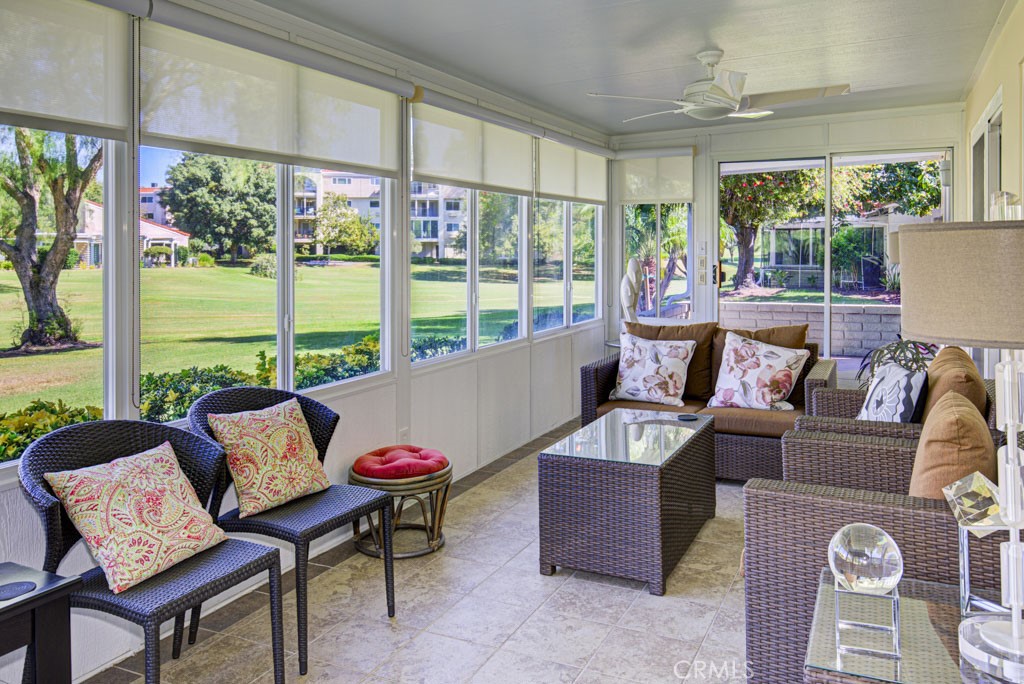 Part of the rear patio has been enclosed creating the perfect space for entertaining, dining and relaxing while taking i - 5516 Paseo Del Lago W A, Laguna Woods CA 92637 - photo 27