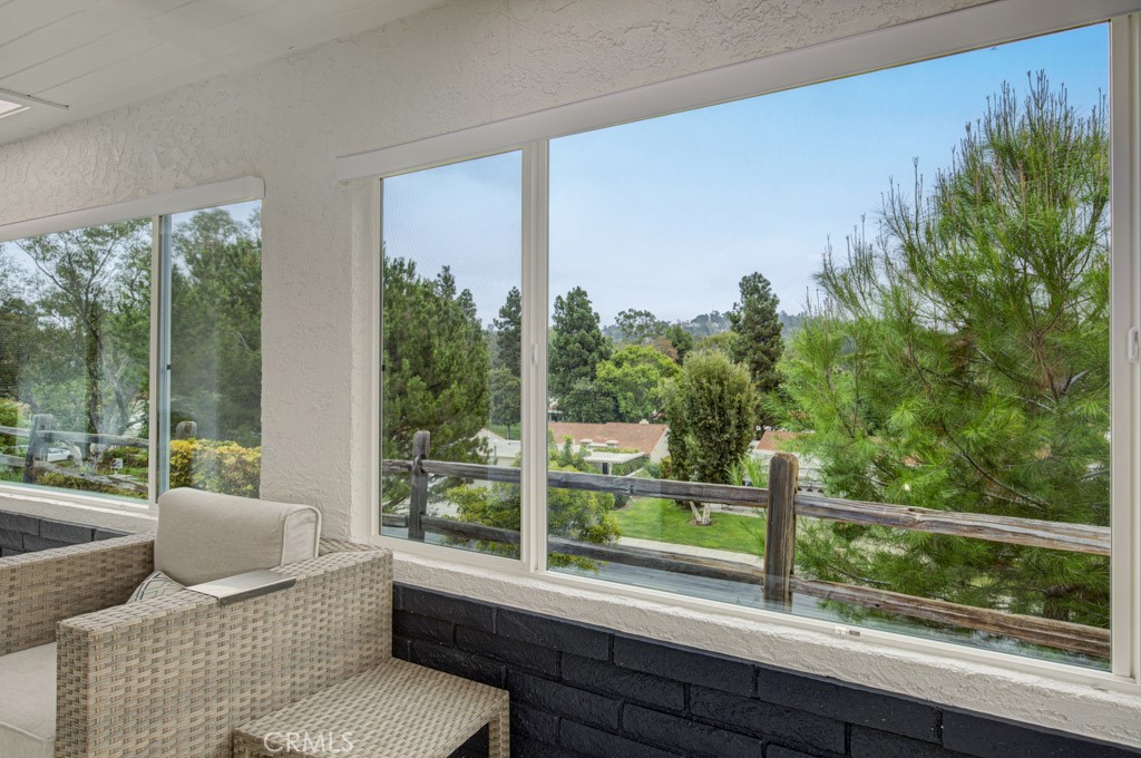 Panoramic view from the rear patio of the neighborhood, trees and hills in the distance. - 5553 Rayo Del Sol B, Laguna Woods CA 92637 - photo 14