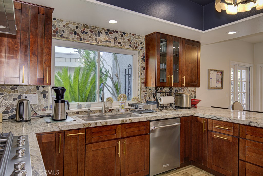 Gorgeous kitchen was recently remodeled and boasts new wood cabinetry with beautiful granite countertops complimented by - 5553 Rayo Del Sol B, Laguna Woods CA 92637 - photo 17