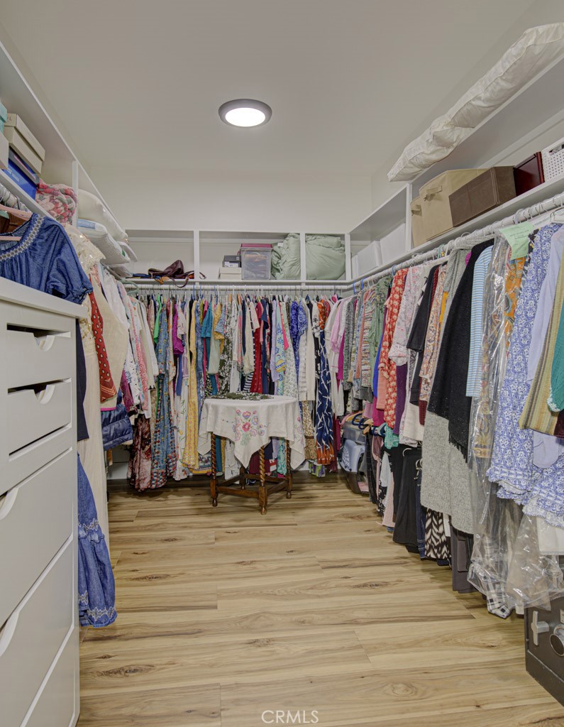 Large walk-in closet in the primary bedroom suite. - 5553 Rayo Del Sol B, Laguna Woods CA 92637 - photo 32