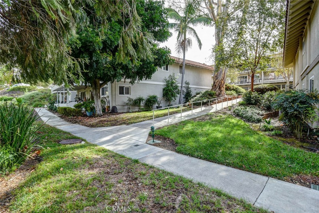 SIDEWALK BACK UP TOWARD NEXT-DOOR BUILDING - 633 Avenida Sevilla O, Laguna Woods CA 92637 - photo 49