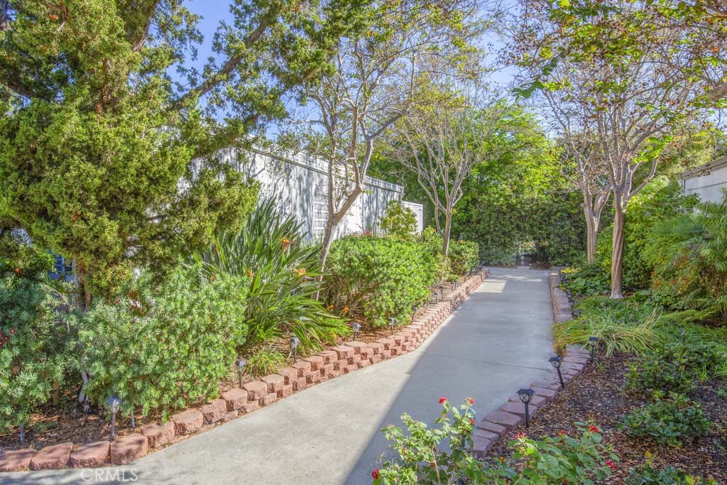 Lushly landscaped walk to the front door of this very private setting. - 645 Avenida Sevilla A, Laguna Woods CA 92637 - photo 1