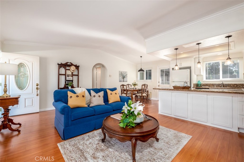 Remodeled kitchen with white shaker cabinets, recessed lights, pendant lights over long breakfast bar, open to great roo - 701 Avenida Sevilla B, Laguna Woods CA 92637 - photo 1