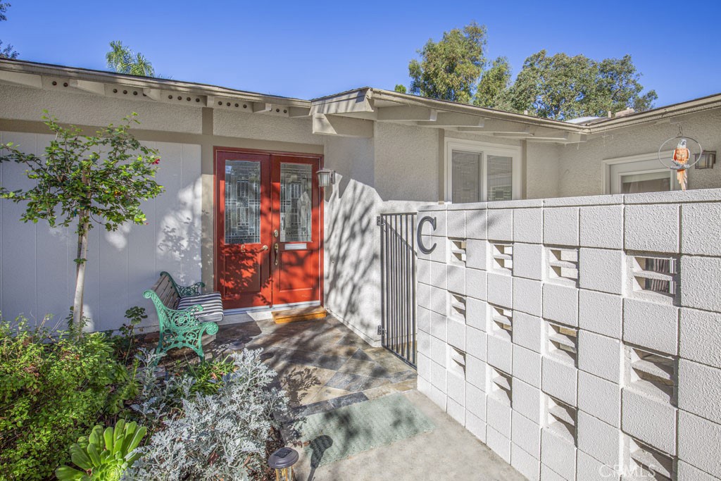 Pretty entry to the home has double doors with leaded glass. - 717 Avenida Majorca C, Laguna Woods CA 92637 - photo 1