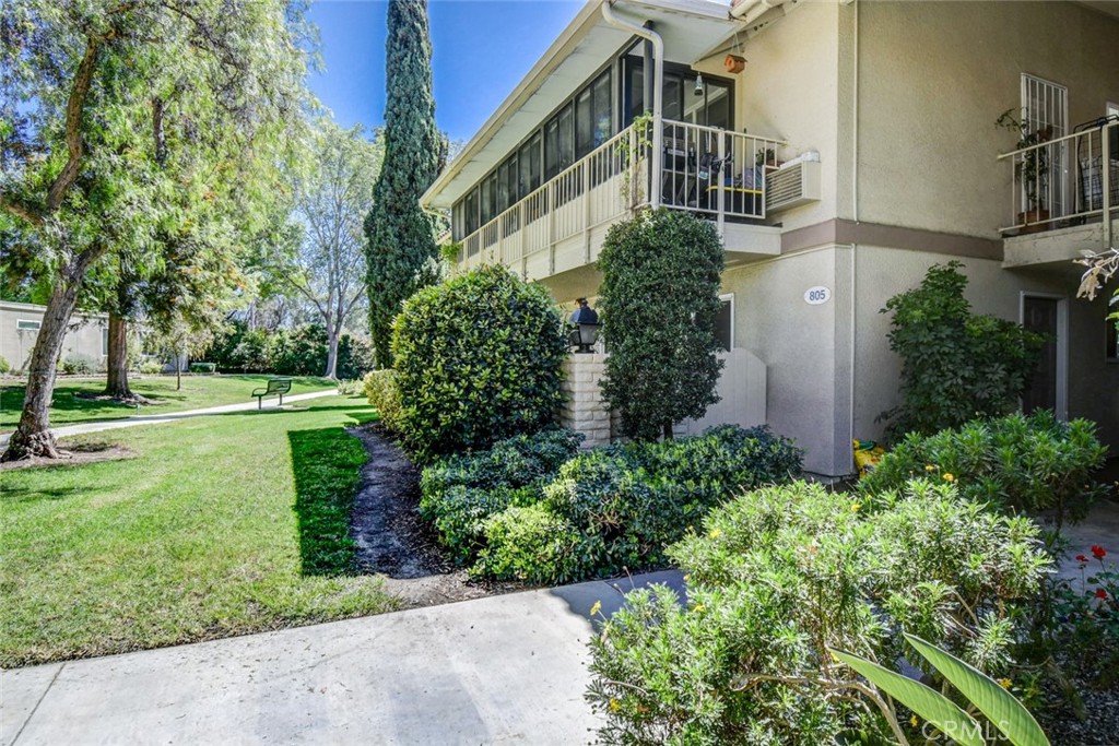 View from outside door showing landscaping and distance between other buildings - 805 Ronda Mendoza B, Laguna Woods CA 92637 - photo 1