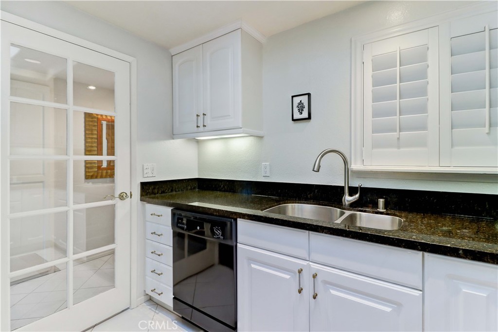 KITCHEN FRENCH DOOR TO FOYER - 881 Via Mendoza O, Laguna Woods CA 92637 - photo 16