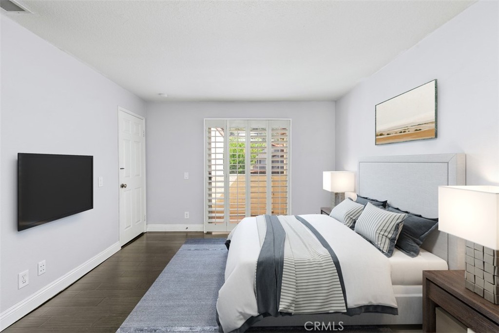 Spacious primary bedroom with nice sized balcony and a storage closet. Note: This image has been virtually staged. - 21227 Camelia 18, Lake Forest CA 92630 - photo 10