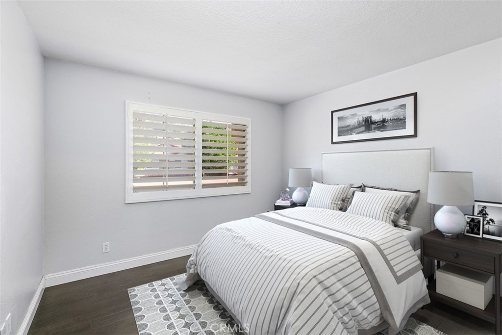 Guest bedroom. Note:This image has been virtually staged. - 21227 Camelia 18, Lake Forest CA 92630 - photo 11