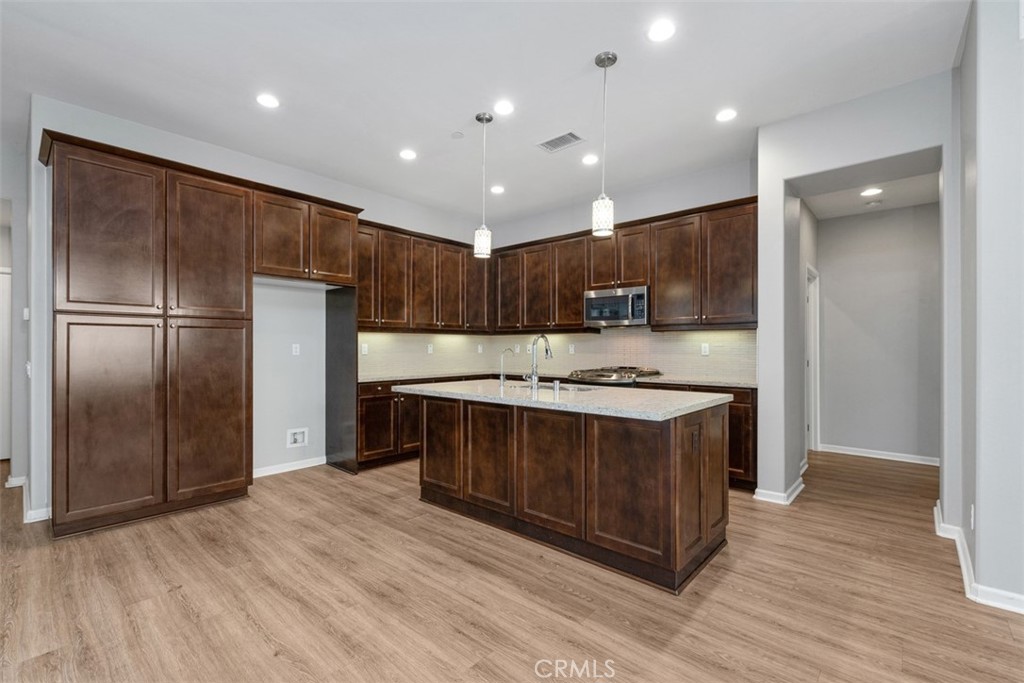Open concept kitchen with oversized island and pendant lighting! - 219 Primrose Drive, Lake Forest CA 92610 - photo 8