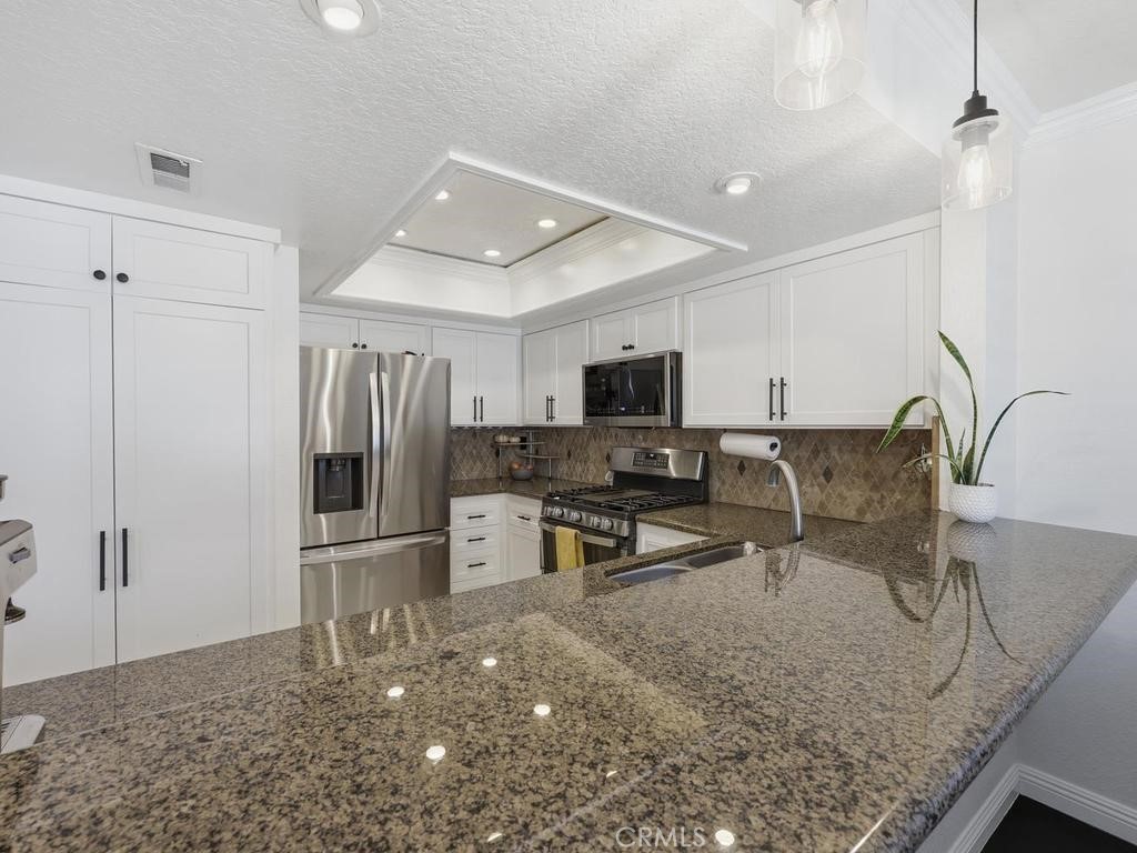 Kitchen open to dinning and breakfast bar counter. - 22185 Cedar Pointe, Lake Forest CA 92630 - photo 15